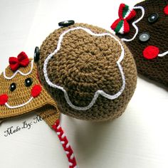 three crocheted hats with red and white bows on them, one has a gingerbread man in the middle