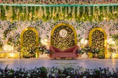 the stage is decorated with flowers and greenery