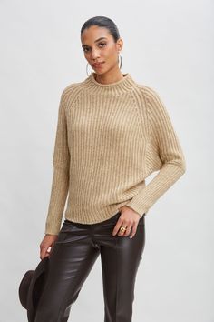 You'll love the subtle shimmer of this Italian metallic wool blend ribbed sweater. Designed with a mock neckline raglan sleeves, this relaxed sweater is perfect for when the temperature drops. You will love the look and feel. Elie Tahari Exclusive Metallic Mock Neck Merino Wool Sweater 42% Merino, 41% Polyamide, 17% Metallic Runs true to Size Model is 5'9" and wearing size XS Dry Clean Only Imported Style #: E95XJ504 Jumpsuit Jacket, Long Sleeve Short Dress, Elie Tahari, Mock Neckline, Merino Wool Sweater, Knit Tees, Mock Neck Sweater, Denim Coat, Knit Jacket