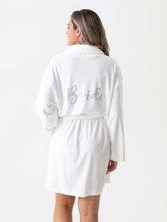 Get ready for your big day in true bridal style with Shiraleah's “Bride” Robe. This luxuriously soft robe features two front pockets and an adjustable wrap around belt, allowing you to be cozy and casual through hours of hair and makeup. Chic and feminine silver rhinestones spell the word “Bride” across the back, helping you to celebrate your wedding day from the moment you step out of the shower. Pair with other items from Shiraleah's Hitched collection to complete your look! Shiraleah is a tre Gifts For The Bride, Soft Robes, Accessories Display, Scarf Hat, Silver Rhinestone, Hair And Makeup, Pj Sets, Perfect Gift For Her, Summer Hats