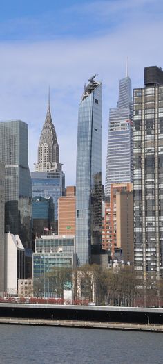 the city skyline is seen from across the water