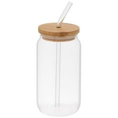 a glass jar with a wooden lid and a straw in it