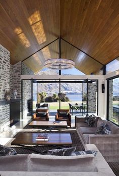 a living room filled with lots of furniture next to a fire place in a house