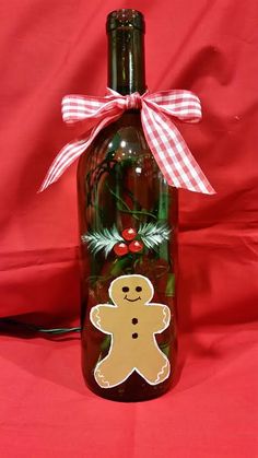 a glass bottle with a gingerbread design on it