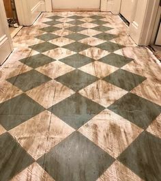 a checkered floor in a house with white and brown doors on either side of the door