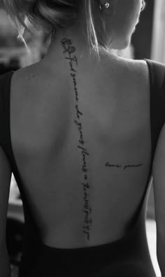 the back of a woman's neck with an inscription written on her left side