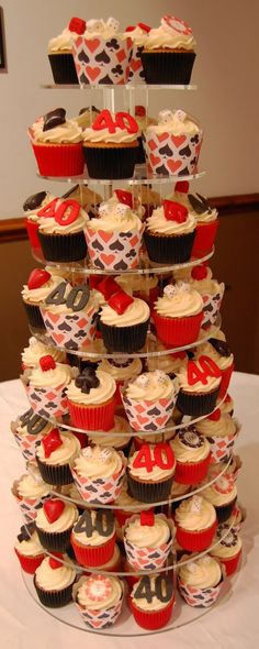 cupcakes are stacked on top of each other in the shape of a tower