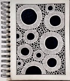 a notebook with black and white designs on it