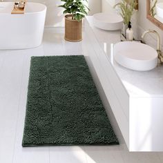 a bath room with two sinks and a rug