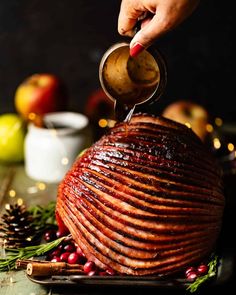 someone is pouring syrup on a roasted turkey