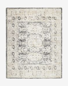 an area rug with a gray and white design on the bottom, in front of a light grey background