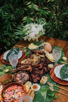 a wooden table topped with lots of food and plates filled with different types of foods