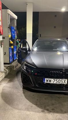 a car is parked in front of a gas station