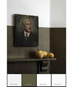 an old painting hangs on the wall next to some fruit