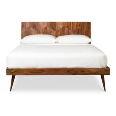 a bed with white sheets and wooden headboard on top of it's frame