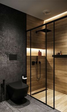 an iphone photo of a bathroom with wooden walls and flooring, including a black toilet