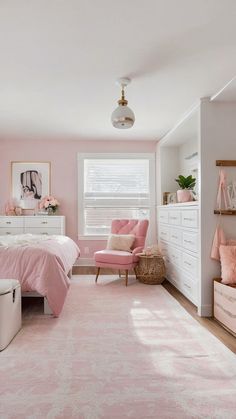 a bedroom decorated in pink and white with a large rug on the floor next to the bed