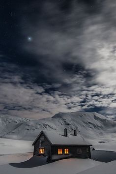 a cabin in the middle of a snowy mountain under a night sky with stars and clouds