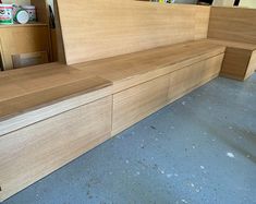 a wooden bench sitting in the middle of a room