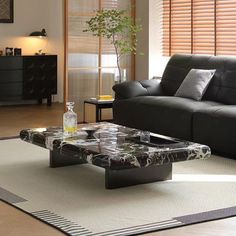 a living room filled with furniture and a rug on top of a hard wood floor