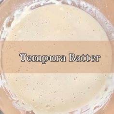 there is a batter in the bowl on top of the table with words that read tempura batter