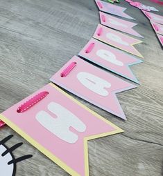 pink and yellow birthday banner with hello kitty on the front, happy birthday sign in the back