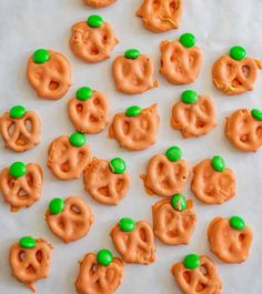 halloween pretzels with green candies in the shape of jack - o'- lanterns