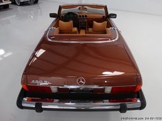 the back end of a brown mercedes 300sl convertible