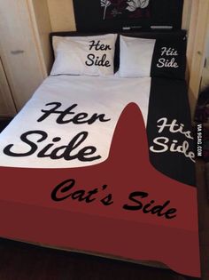 a bed with black and red sheets that say cat's side on the bottom