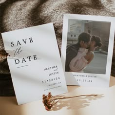 save the date cards on top of a bed next to an envelope with a photo