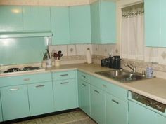 a kitchen with light blue cabinets and white counter tops is pictured in this image from the front view