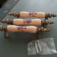 three wooden handles with flowers painted on them