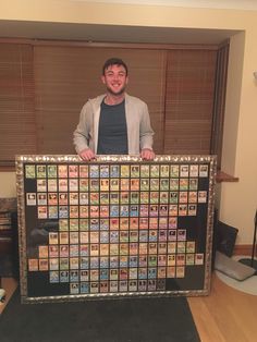 a man standing behind a large metal framed calendar