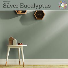 an advertisement for silver eucalyptuss on the wall next to a small table and clock