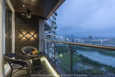 a balcony with chairs, table and view of the city from it's windows