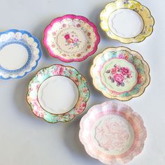 five plates with different designs on them sitting next to each other