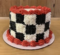 a cake decorated with black, white and red flowers