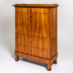 an antique chest of drawers with black handles