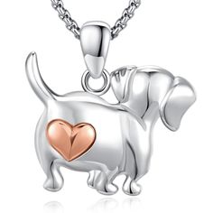 a silver and gold dog with a heart pendant on it's back, in the shape