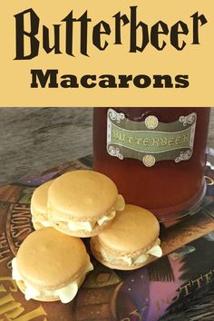 three butterbeer macarons sitting on top of a book