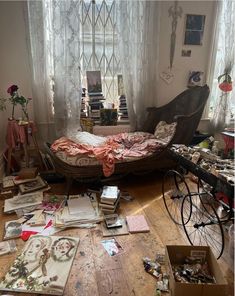 a messy bedroom with an unmade bed and lots of papers on the floor next to it