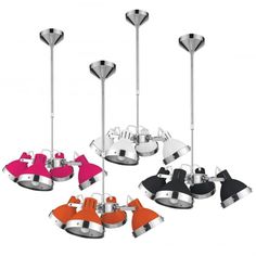 an assortment of different colored lights hanging from metal poles with black, white, and pink shades