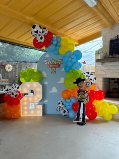 the balloon arch is decorated with pandas and balloons for an animal themed birthday party