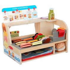 a wooden toy kitchen with lots of food