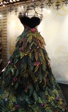 a dress made out of leaves on display