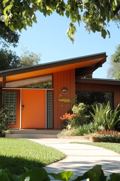 a house with orange doors in the front yard