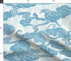 a blue and white fabric with clouds on it