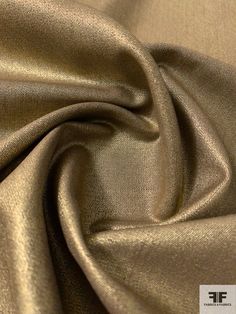 a close up view of a gold colored fabric