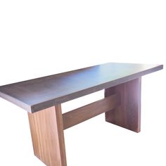 a long wooden table sitting on top of a white wall