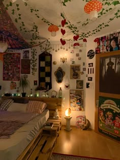 a bedroom with lots of decorations hanging from the ceiling and lights on the wall above the bed